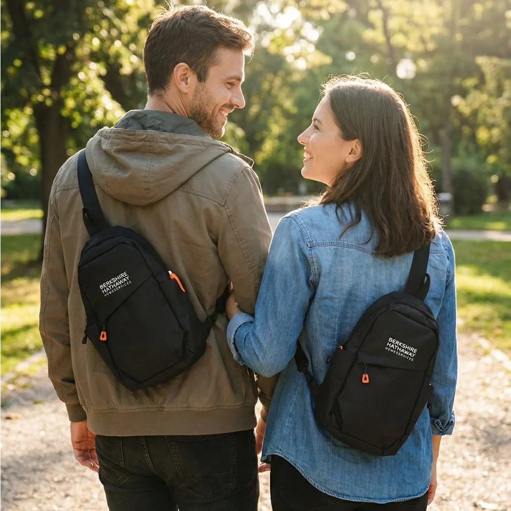 Waterproof Travel Sling Bag- Unisex. Black with Orange accents.